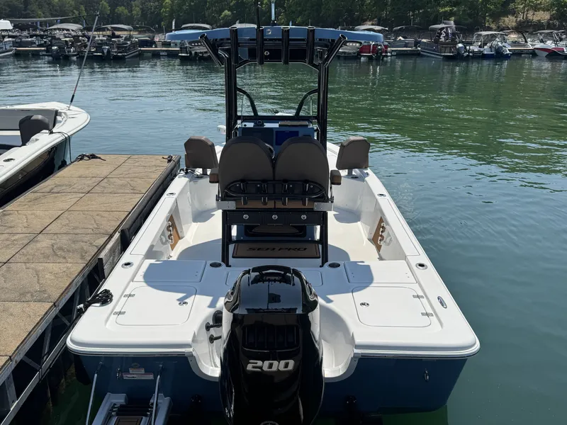 Slide: The Image of 2026 Sea Pro 230 DLX boat docked, calm waters. - 4