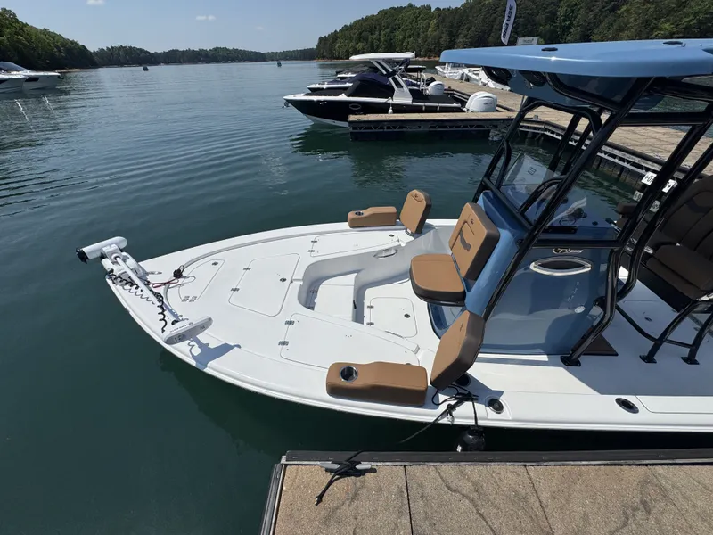 Slide: The Image of 2026 Sea Pro 230 DLX boat docked on calm water. - 6