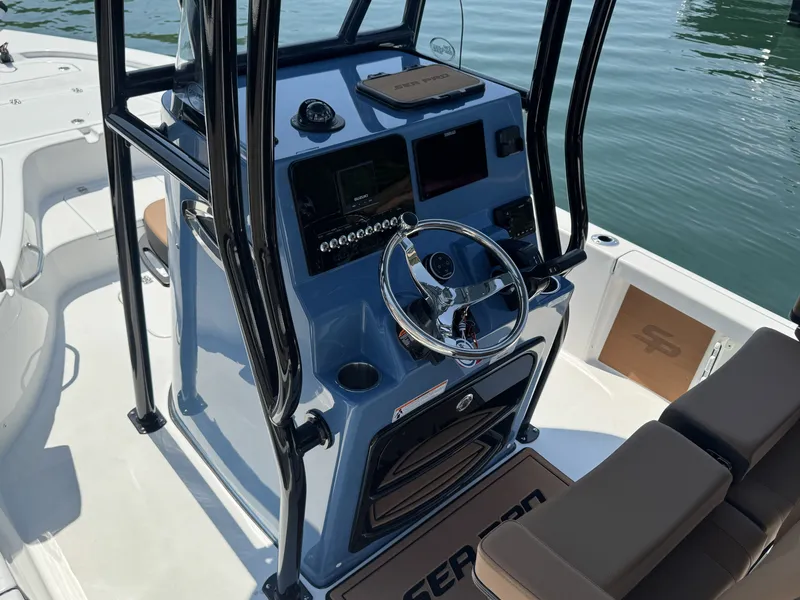 Slide: The Image of Interior view of 2026 Sea Pro 230 DLX boat with helm console. - 7