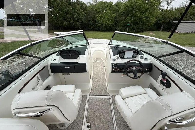 Slide: The Image of 2008 Sea Ray 270 SLX boat interior with white seating and modern dashboard. - 10