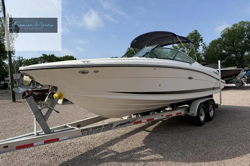 Slide: The Image of 2008 Sea Ray 270 SLX boat on trailer, parked outdoors under clear sky. - 11