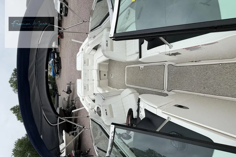Slide: The Image of Interior view of a 2008 Sea Ray 270 SLX boat with white seating and carpeted floor. - 12