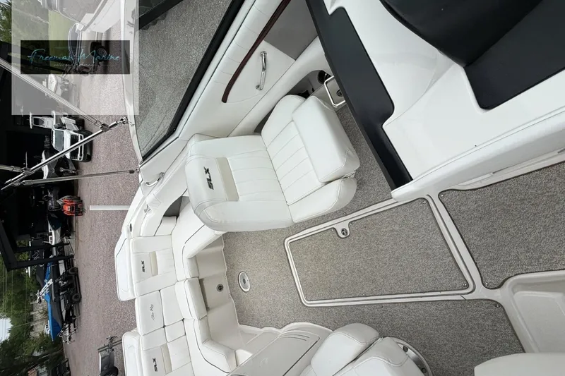 Slide: The Image of Interior view of a 2008 Sea Ray 270 SLX boat with white seating and carpeted flooring. - 13