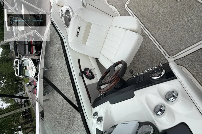 Slide: The Image of 2008 Sea Ray 270 SLX boat interior with white seating and control panel. - 14