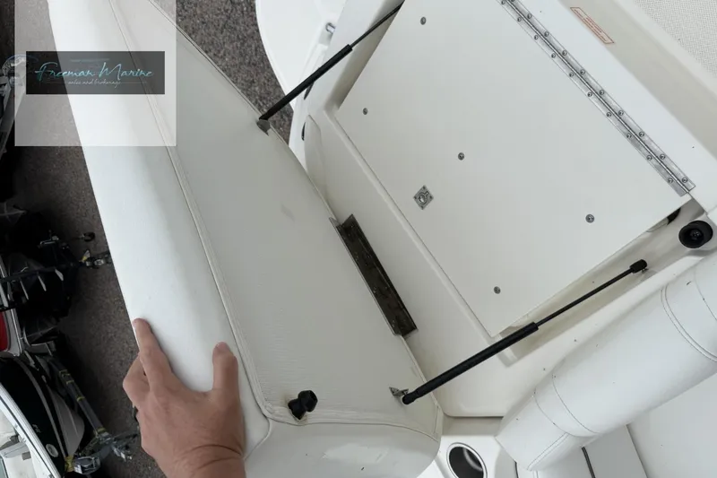 Slide: The Image of 2008 Sea Ray 270 SLX boat interior with storage compartment and cushioned seating. - 17