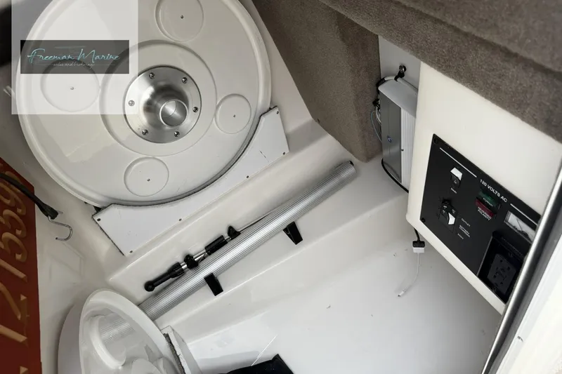 Slide: The Image of Interior view of a 2008 Sea Ray 270 SLX boat, featuring storage and control panel. - 20