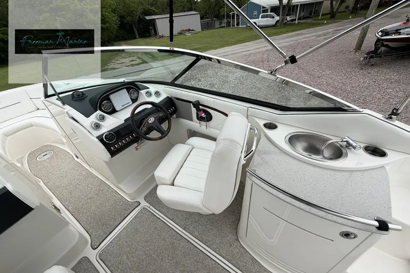 Slide: The Image of 2008 Sea Ray 270 SLX boat interior with helm, steering wheel, and sink. - 24