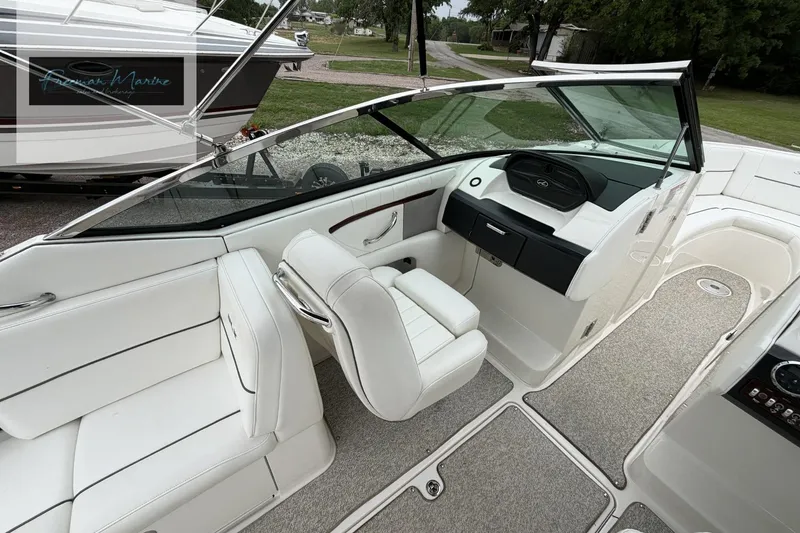 Slide: The Image of 2008 Sea Ray 270 SLX boat interior with white seating and modern dashboard design. - 25