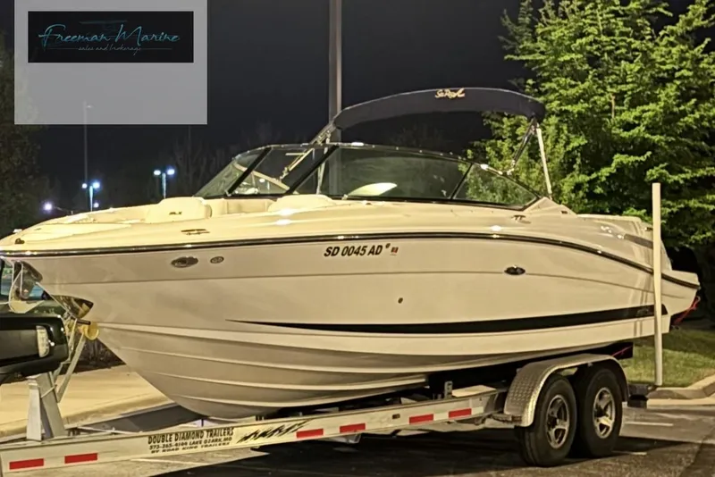 Slide: The Image of 2008 Sea Ray 270 SLX boat on trailer at night, Freeman Marine logo visible. - 31
