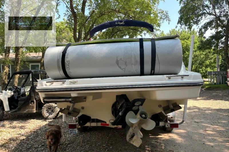 Slide: The Image of 2008 Sea Ray 270 SLX boat with rolled mat on deck, parked outdoors. - 33