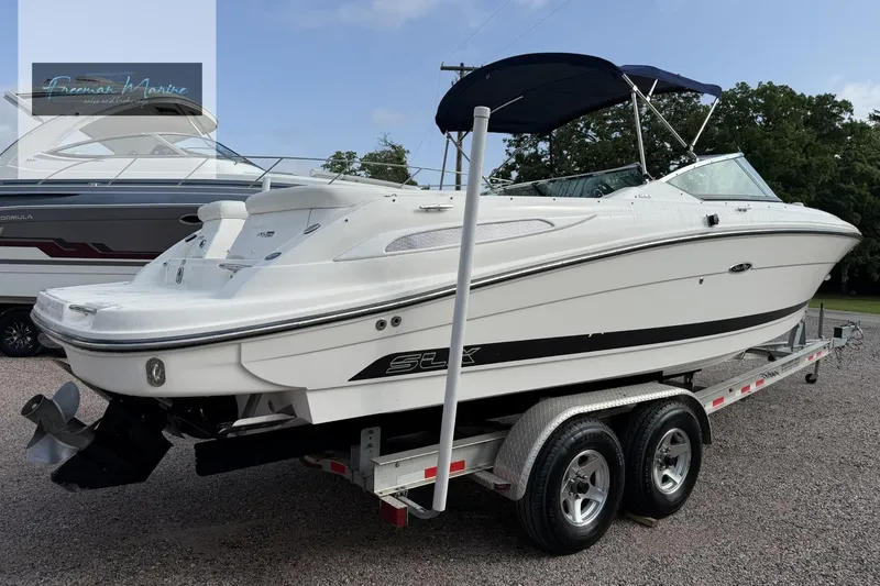 Slide: The Image of 2008 Sea Ray 270 SLX boat on trailer, white exterior, parked outdoors. - 5