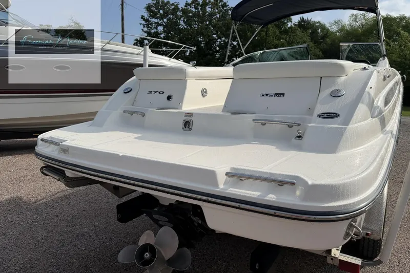 Slide: The Image of 2008 Sea Ray 270 SLX boat with sleek design, rear view, and visible propeller. - 7