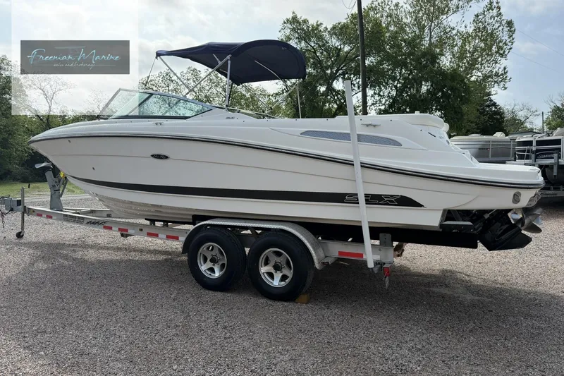 Slide: The Image of 2008 Sea Ray 270 SLX boat on trailer, featuring sleek design and canopy. - 9