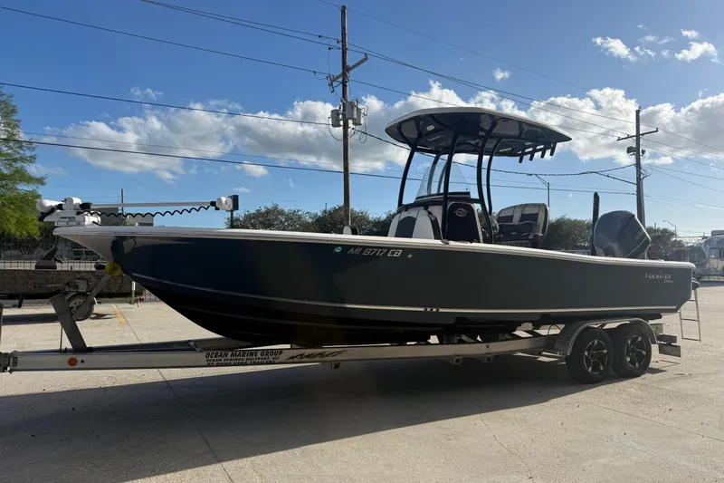 Slide: The Image of 2021 Tidewater 2500 Carolina Bay boat on trailer under clear blue sky. - 3
