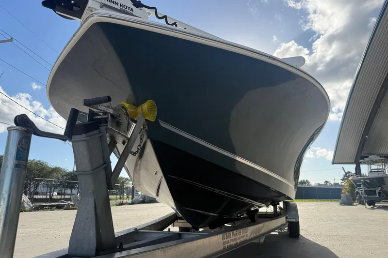 Slide: The Image of 2021 Tidewater 2500 Carolina Bay boat on trailer under a sunny sky. - 4