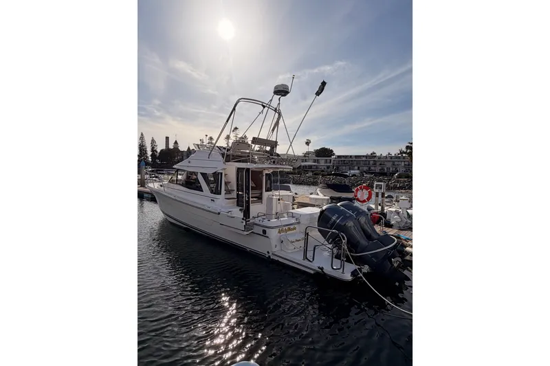 Slide: The Image of 2021 Cutwater C-32 CB boat docked at marina, showcasing rear deck and cabin. - 10
