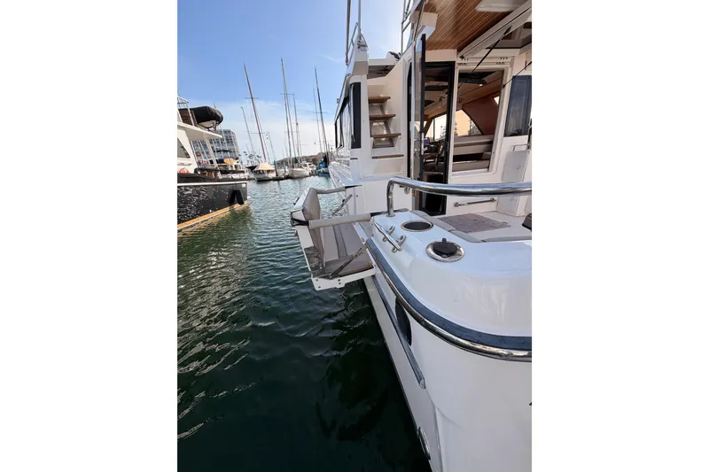 Slide: The Image of 2021 Cutwater C-32 CB boat deck with railing and dock view. - 17