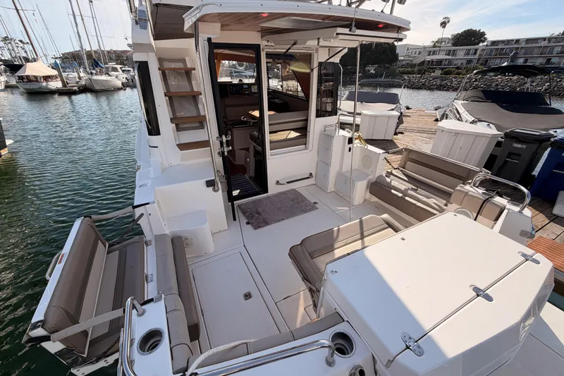 Slide: The Image of 2021 Cutwater C-32 CB boat docked with visible outboard motors and marina surroundings. - 18