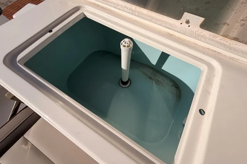 Slide: The Image of 2021 Cutwater C-32 CB boat interior with seating and speaker, docked at marina. - 22