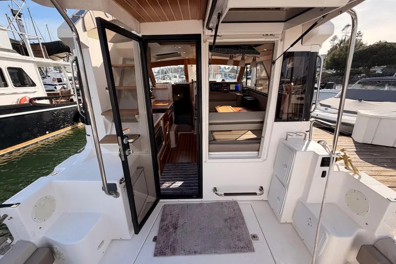 Slide: The Image of 2021 Cutwater C-32 CB boat deck with seating and storage, docked at marina. - 23