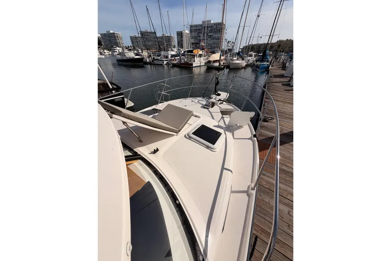 Slide: The Image of 2021 Cutwater C-32 CB boat with open storage compartment and seating area. - 24