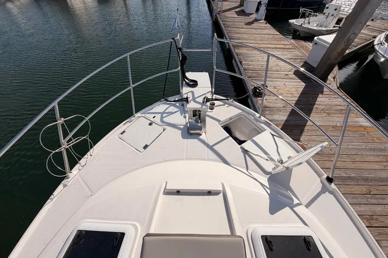 Slide: The Image of 2021 Cutwater C-32 CB boat interior view with open doors and dockside setting. - 26