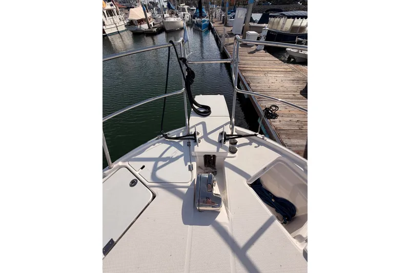Slide: The Image of 2021 Cutwater C-32 CB boat docked in a marina with sailboats and buildings. - 27