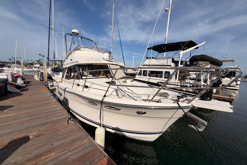 Slide: The Image of 2021 Cutwater C-32 CB boat docked at marina with twin Yamaha engines. - 3