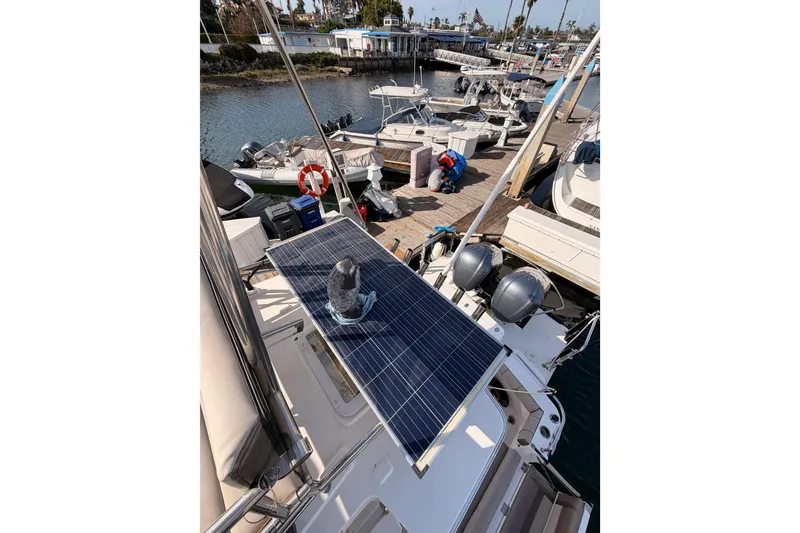 Slide: The Image of 2021 Cutwater C-32 CB boat helm with steering wheel and controls at marina dock. - 33