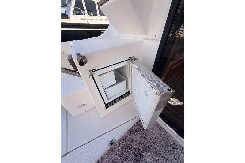 Slide: The Image of 2021 Cutwater C-32 CB boat helm with navigation equipment at marina dock. - 34