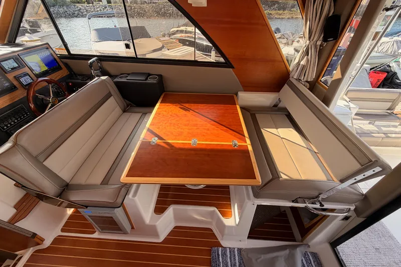Slide: The Image of 2021 Cutwater C-32 CB cabin interior with control panels and wood accents. - 43