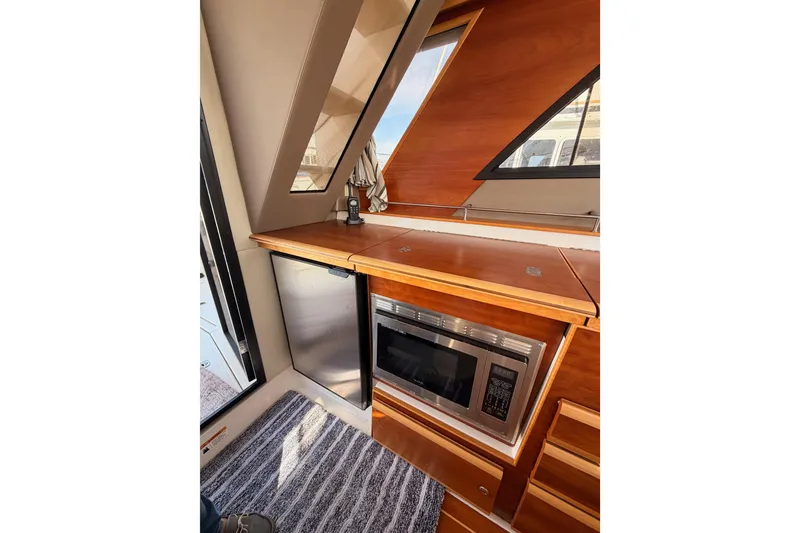 Slide: The Image of 2021 Cutwater C-32 CB cabin interior with control panel and carpeted flooring. - 44