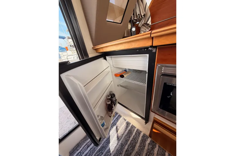 Slide: The Image of 2021 Cutwater C-32 CB cabin interior with patterned flooring and control panels. - 45