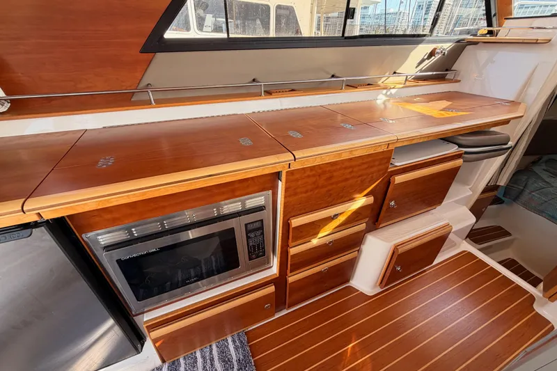Slide: The Image of Interior of 2021 Cutwater C-32 CB boat with elegant seating and wooden table. - 46