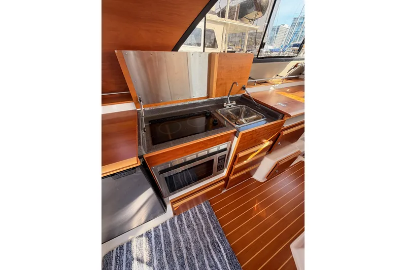 Slide: The Image of Interior of 2021 Cutwater C-32 CB yacht with wooden cabinetry and modern appliances. - 47