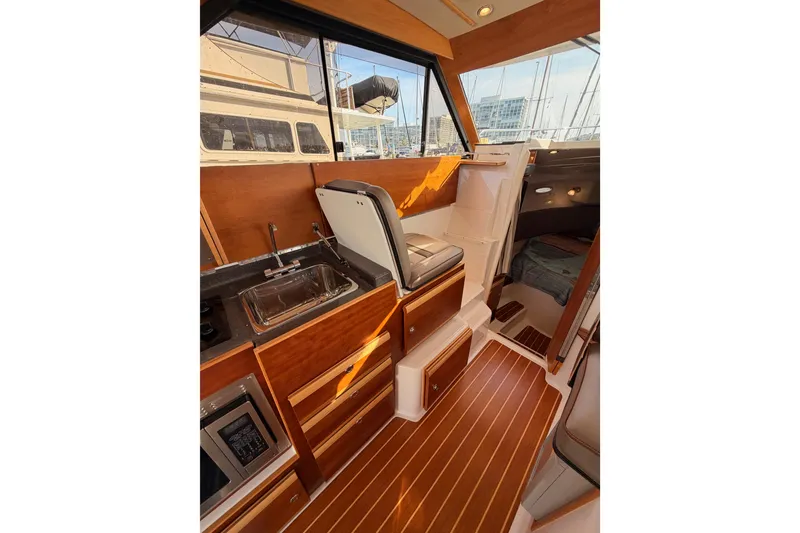 Slide: The Image of 2021 Cutwater C-32 CB yacht interior with open mini fridge and beverages. - 48