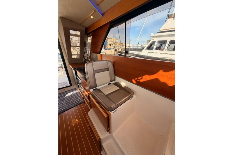 Slide: The Image of 2021 Cutwater C-32 CB interior with wooden cabinetry and built-in microwave. - 49