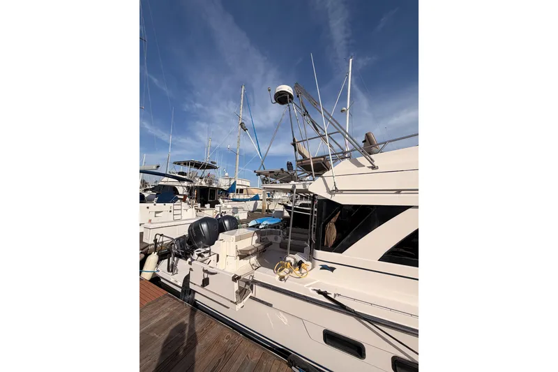 Slide: The Image of 2021 Cutwater C-32 CB boat docked at a marina under a clear sky. - 5
