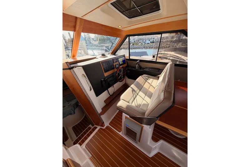Slide: The Image of 2021 Cutwater C-32 CB yacht interior kitchen with sink, stove, and microwave. - 50