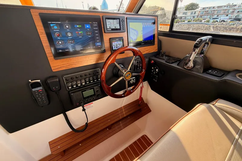 Slide: The Image of Interior of 2021 Cutwater C-32 CB boat with wood finish and compact kitchen area. - 51