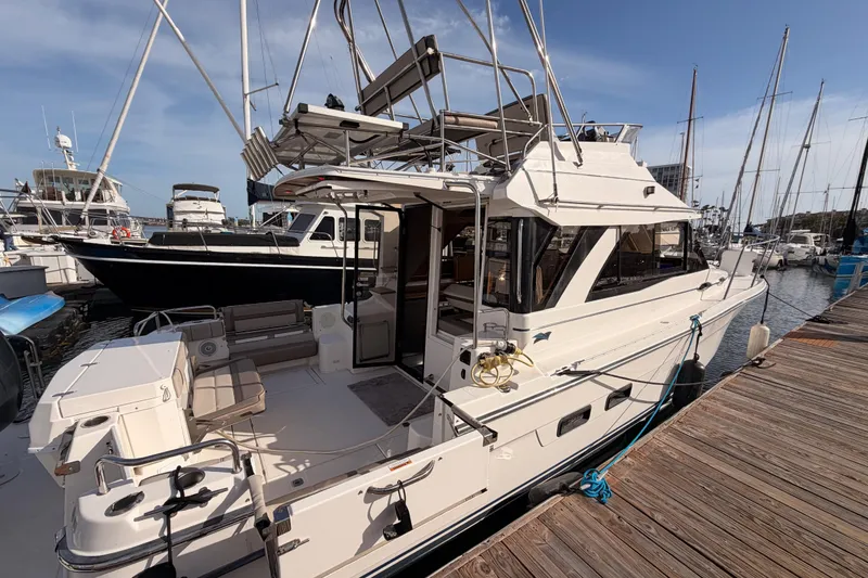 Slide: The Image of 2021 Cutwater C-32 CB boat docked at a marina under a clear blue sky. - 6
