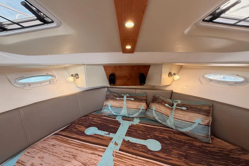 Slide: The Image of Cozy cabin interior of 2021 Cutwater C-32 CB with nautical-themed bedding. - 60