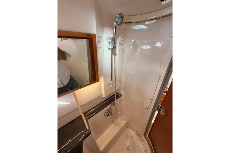 Slide: The Image of 2021 Cutwater C-32 CB boat bathroom with shower, sink, and mirror. - 66