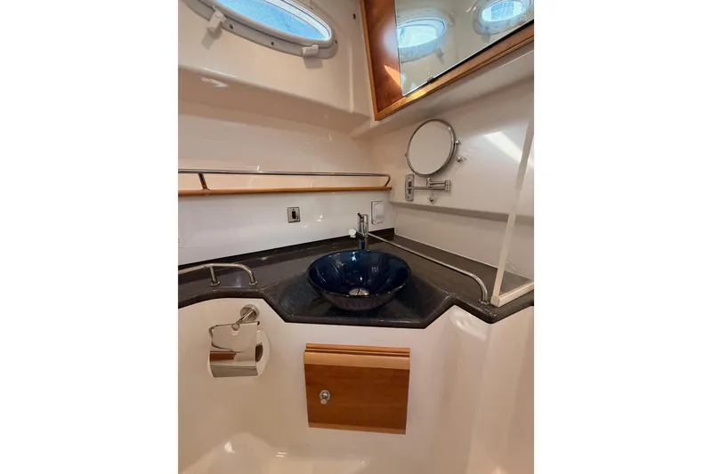 Slide: The Image of Manufacturer Provided Image: 2021 Cutwater C-32 CB boat bathroom with modern fixtures and blue sink. - 68