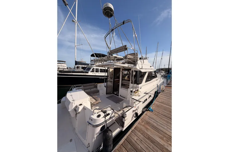 Slide: The Image of 2021 Cutwater C-32 CB yacht docked at marina under clear blue sky. - 7