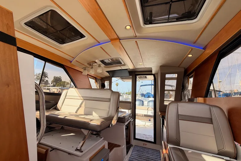 Slide: The Image of 2021 Cutwater C-32 CB boat shower with modern fixtures and wooden accents. - 70