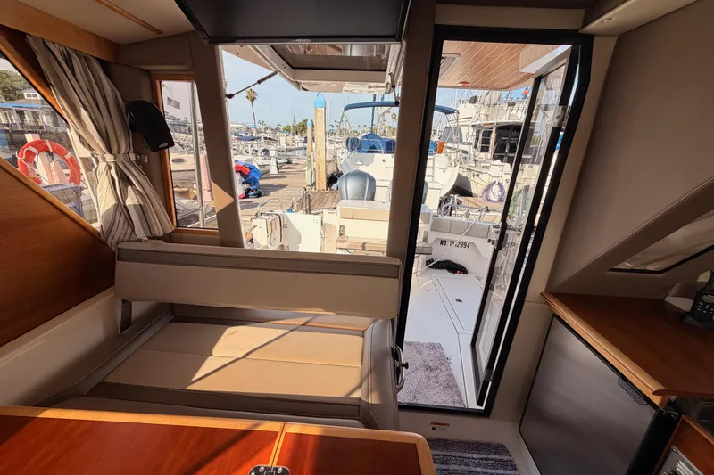 Slide: The Image of Interior view of 2021 Cutwater C-32 CB yacht, showcasing seating and marina backdrop. - 76
