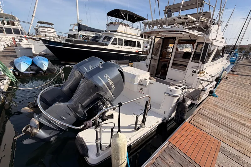 Slide: The Image of 2021 Cutwater C-32 CB boat docked at marina under clear blue sky. - 8