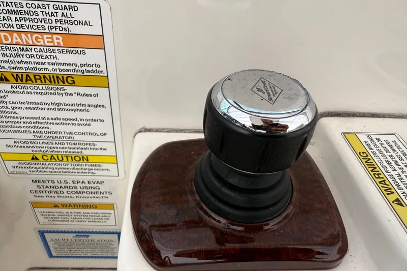Slide: The Image of Close-up of a 2012 Sea Ray Sundancer 310 boat control knob with safety warnings. - 10