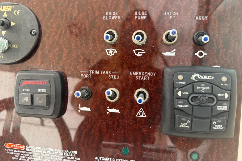 Slide: The Image of Control panel of a 2012 Sea Ray Sundancer 310 boat with various switches and buttons. - 12